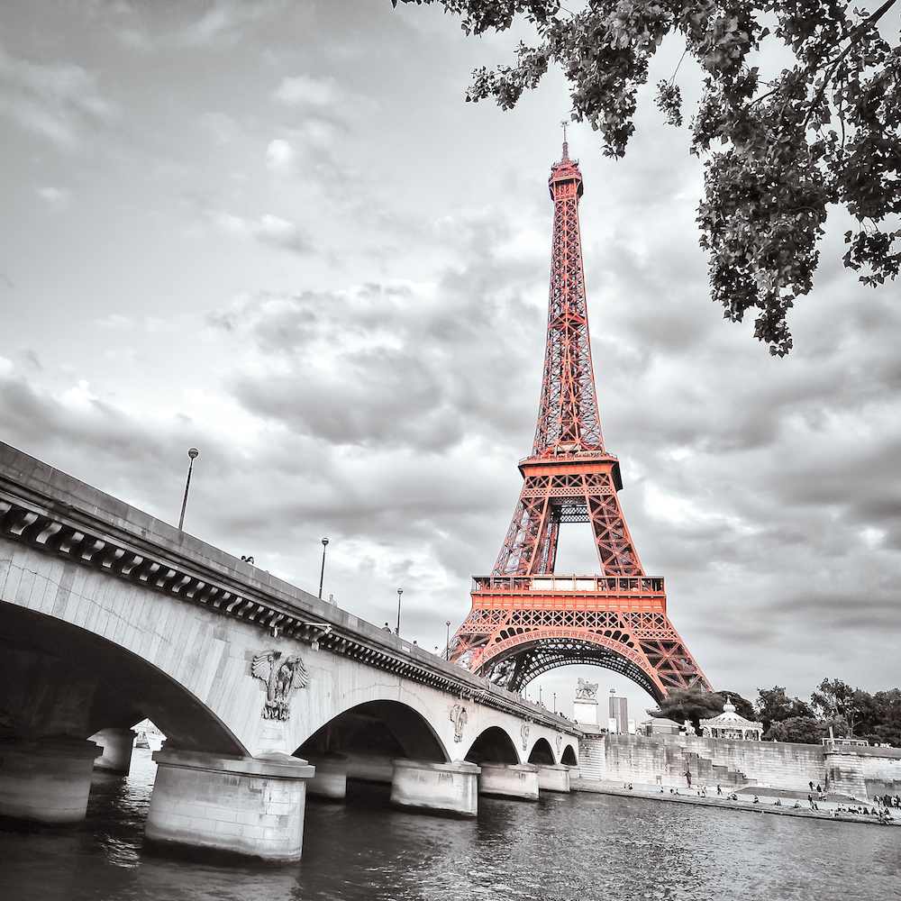 Monochrome view of Eiffel tower and bridge with selective colorization