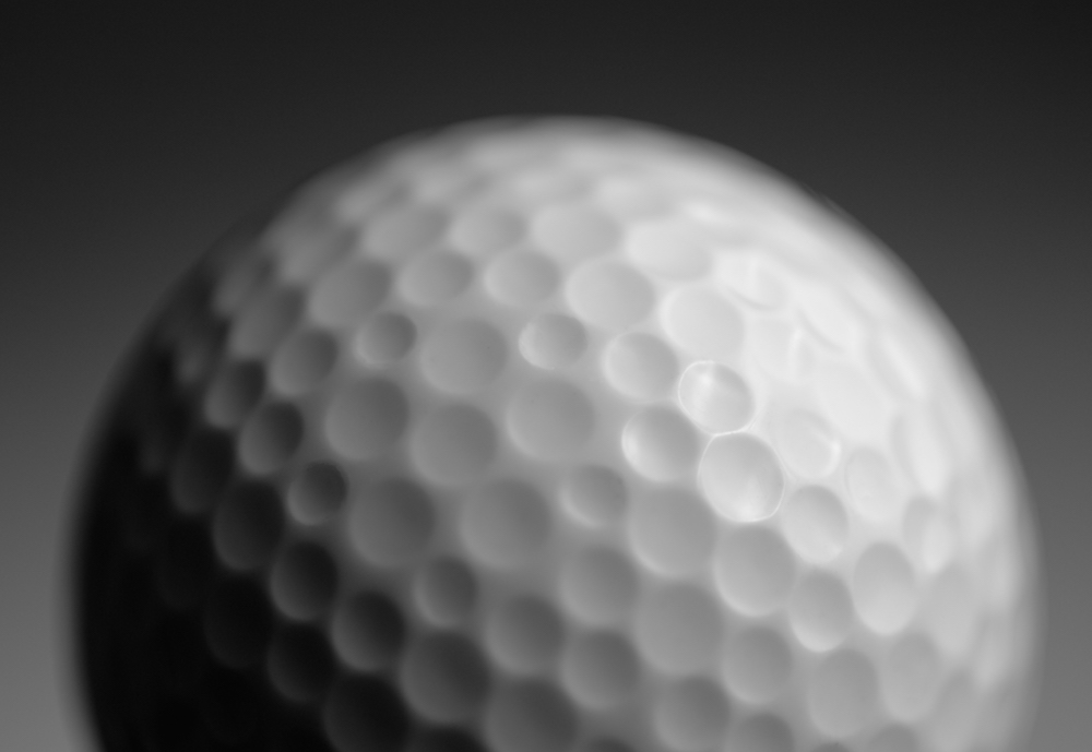 golf ball in black and white with very shallow depth of field and soft focus